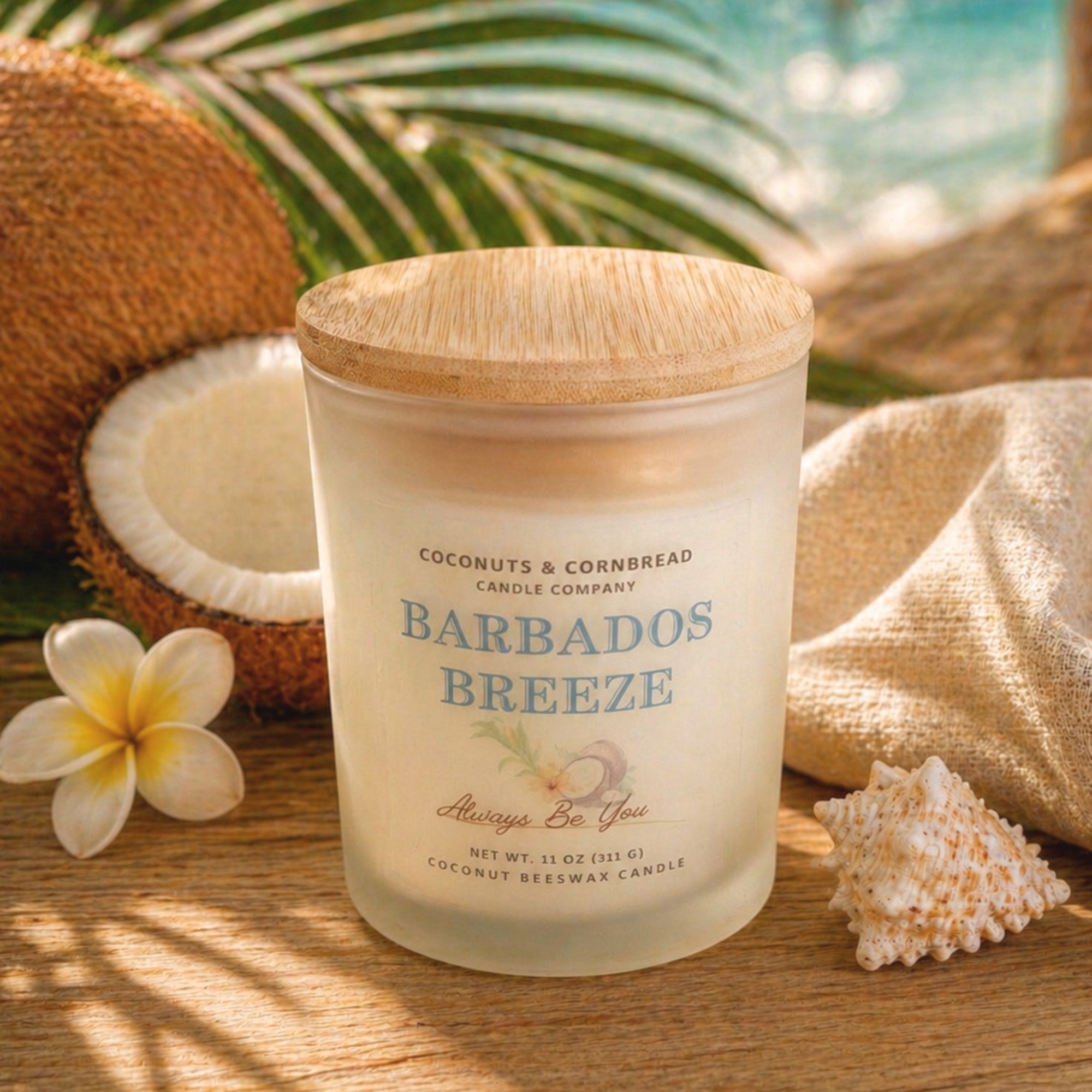 Candle labeled 'Barbados Breeze' from Coconuts & Cornbread Candle Company with coconuts, a shell, and a flower in the background.